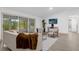 Comfortable living room featuring light beige couch and armchairs at 27100 Racquet Cir, Leesburg, FL 34748