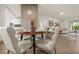 Open-concept living and dining area with modern decor, wood floors, and plenty of natural light at 27100 Racquet Cir, Leesburg, FL 34748