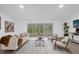 Relaxing living room with sliding glass doors leading to patio at 27100 Racquet Cir, Leesburg, FL 34748