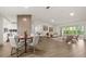 Spacious open-concept living area with wood floors, dining space, and modern decor at 27100 Racquet Cir, Leesburg, FL 34748