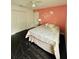Bedroom with a queen bed and coral-colored wall at 2793 Hudson St, Lakeland, FL 33810