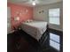 Bedroom with a queen bed and coral-colored wall at 2793 Hudson St, Lakeland, FL 33810