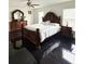 Large bedroom with dark wood furniture and black tile floors at 2793 Hudson St, Lakeland, FL 33810