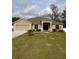 Tan house with a two-car garage and a well-maintained lawn at 2793 Hudson St, Lakeland, FL 33810
