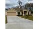 Tan house with a driveway and a lush green lawn at 2793 Hudson St, Lakeland, FL 33810