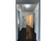 Long hallway with black tile floor and access to bathroom at 2793 Hudson St, Lakeland, FL 33810