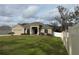 Tan house with a two-car garage and a green lawn at 2793 Hudson St, Lakeland, FL 33810