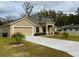 Tan house with a two-car garage and a long driveway at 2793 Hudson St, Lakeland, FL 33810