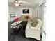 Living room with two beige sofas, a large TV, and black tile floors at 2793 Hudson St, Lakeland, FL 33810