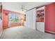 Bright bedroom with built-in shelving and window at 3096 Lansing Way, The Villages, FL 32162
