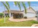 Tan one-story house with attached garage and landscaping at 3096 Lansing Way, The Villages, FL 32162