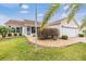 Tan one-story house with attached garage, landscaping, and brick walkway at 3096 Lansing Way, The Villages, FL 32162