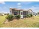 Exterior view of home with screened porch at 3096 Lansing Way, The Villages, FL 32162