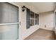 Front porch with screen door, window shutters, and neutral colored flooring at 3096 Lansing Way, The Villages, FL 32162