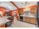 Kitchen features a breakfast bar, dining area view, and orange walls at 3096 Lansing Way, The Villages, FL 32162