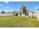 Spacious backyard with grassy area, privacy fence, and patio at 8638 Triumph Cir, Wildwood, FL 34785