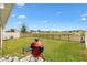 Large backyard with a grill and open space at 8638 Triumph Cir, Wildwood, FL 34785