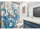 Nautical-themed bathroom with navy vanity at 8638 Triumph Cir, Wildwood, FL 34785