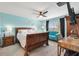 Main bedroom with a sleigh bed, light blue walls, and a teal accent chair at 8638 Triumph Cir, Wildwood, FL 34785