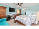 Bedroom with wooden sleigh bed and coastal-themed bedding at 8638 Triumph Cir, Wildwood, FL 34785