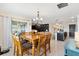 Dining area with a wooden table and chairs, near kitchen and living room at 8638 Triumph Cir, Wildwood, FL 34785