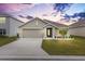 One-story house with a two-car garage and landscaped yard at 8638 Triumph Cir, Wildwood, FL 34785