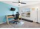 Bright home office features a desk, chair, and large window at 8638 Triumph Cir, Wildwood, FL 34785