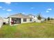 Backyard view of the house, showing a patio and lawn at 8638 Triumph Cir, Wildwood, FL 34785