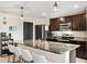 Modern kitchen with granite countertops and island seating at 8638 Triumph Cir, Wildwood, FL 34785