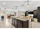 Island kitchen with granite countertops and stainless steel appliances at 8638 Triumph Cir, Wildwood, FL 34785