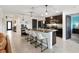 Open concept kitchen with an island and stainless steel appliances at 8638 Triumph Cir, Wildwood, FL 34785