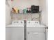 Laundry room with washer, dryer, and shelving at 8638 Triumph Cir, Wildwood, FL 34785