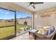 Relaxing screened porch with patio furniture and grill at 8638 Triumph Cir, Wildwood, FL 34785