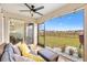 Screened porch with backyard view and seating at 8638 Triumph Cir, Wildwood, FL 34785