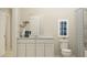 Simple bathroom with white vanity, toilet, and shower with patterned curtain at 2031 Stake Out Way, Apopka, FL 32703