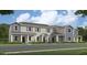 Two-story townhome with gray siding, blue accents, and a welcoming front porch at 2031 Stake Out Way, Apopka, FL 32703