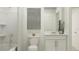 Clean bathroom with white vanity, tub shower combo, and gray accents at 4192 Singing Mockingbird Blvd, Bartow, FL 33830