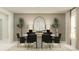 Elegant dining room featuring a round table, black chairs, and a statement mirror at 4192 Singing Mockingbird Blvd, Bartow, FL 33830