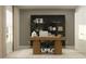 Modern home office with a wooden desk, glass-front cabinets, and rug at 4192 Singing Mockingbird Blvd, Bartow, FL 33830