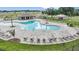 Aerial view of community pool, lounge chairs, and playground at 4212 Singing Mockingbird Blvd, Bartow, FL 33830