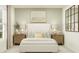 Bedroom with a light and airy feel, featuring a white bed and wood furniture at 4212 Singing Mockingbird Blvd, Bartow, FL 33830