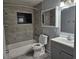 Bathroom with gray vanity, tiled shower, and medicine cabinet at 112 Jasper St, Bushnell, FL 33513