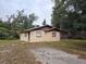 Tan single story house with brown roof and a carport at 112 Jasper St, Bushnell, FL 33513