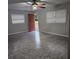 Living room with tiled floors, red door and ceiling fan at 112 Jasper St, Bushnell, FL 33513