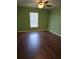 Bright room featuring hardwood floors, a ceiling fan, and a large window at 2157 Geneva Dr, Lakeland, FL 33805