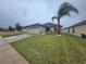 One-story house with green exterior, attached garage, and palm tree at 2157 Geneva Dr, Lakeland, FL 33805