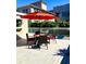 Relaxing deck with red umbrella and patio furniture at 311 N Baker St, Mount Dora, FL 32757