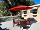 Outdoor deck with table, chairs, and red umbrella at 311 N Baker St, Mount Dora, FL 32757