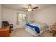 Comfortable bedroom with a queen-size bed and ceiling fan, well-lit room at 10984 Sw 81St Ave, Ocala, FL 34481