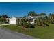 Single-story home with attached garage, landscaped lawn, and palm trees at 10984 Sw 81St Ave, Ocala, FL 34481